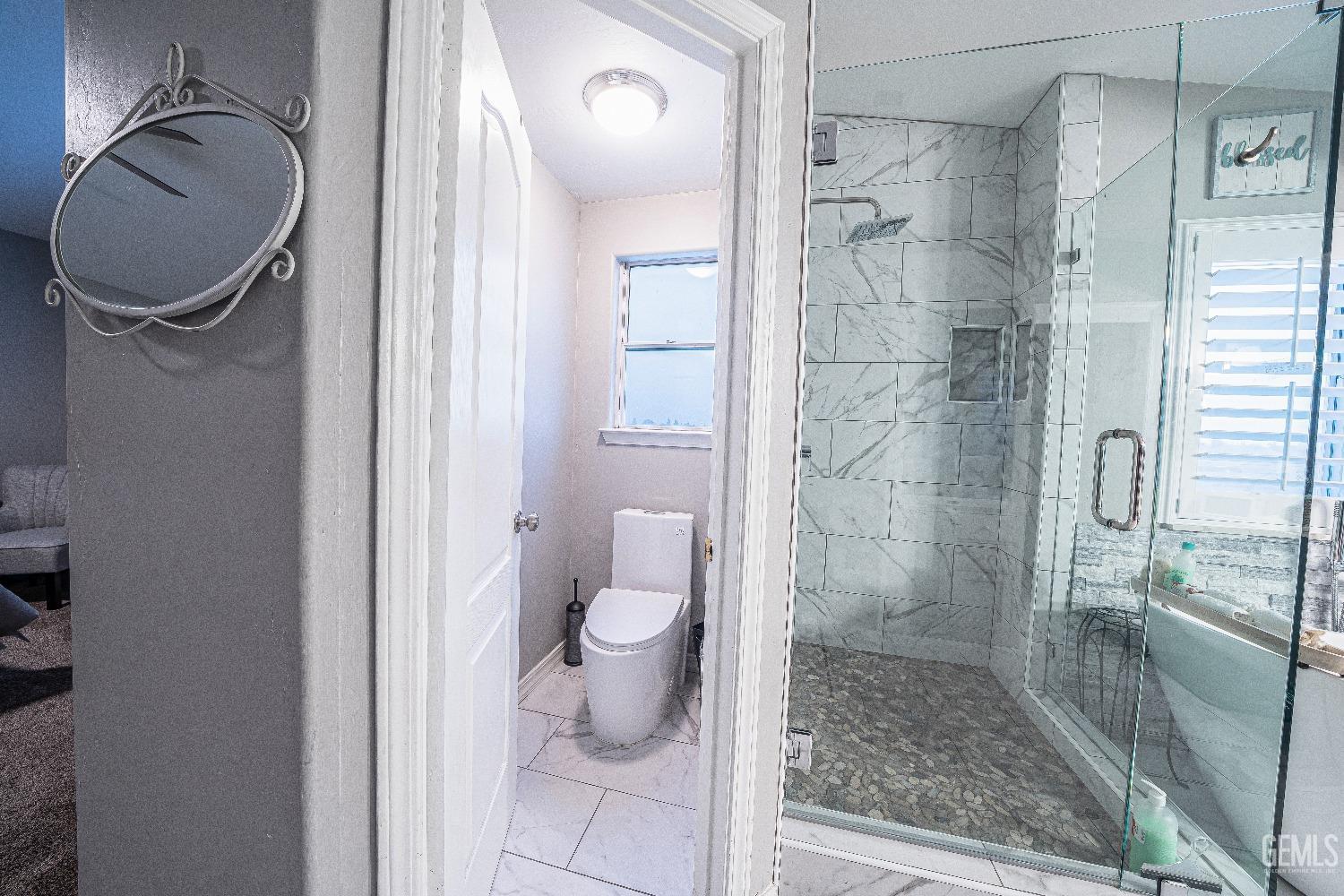 Undisclosed Address Bakersfield, CA 93312 - Photo 18 of 29 a bathroom with a toilet and a shower