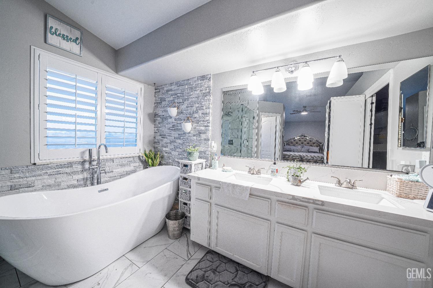 Undisclosed Address Bakersfield, CA 93312 - Photo 19 of 29 a bathroom with a large tub sink and double vanity