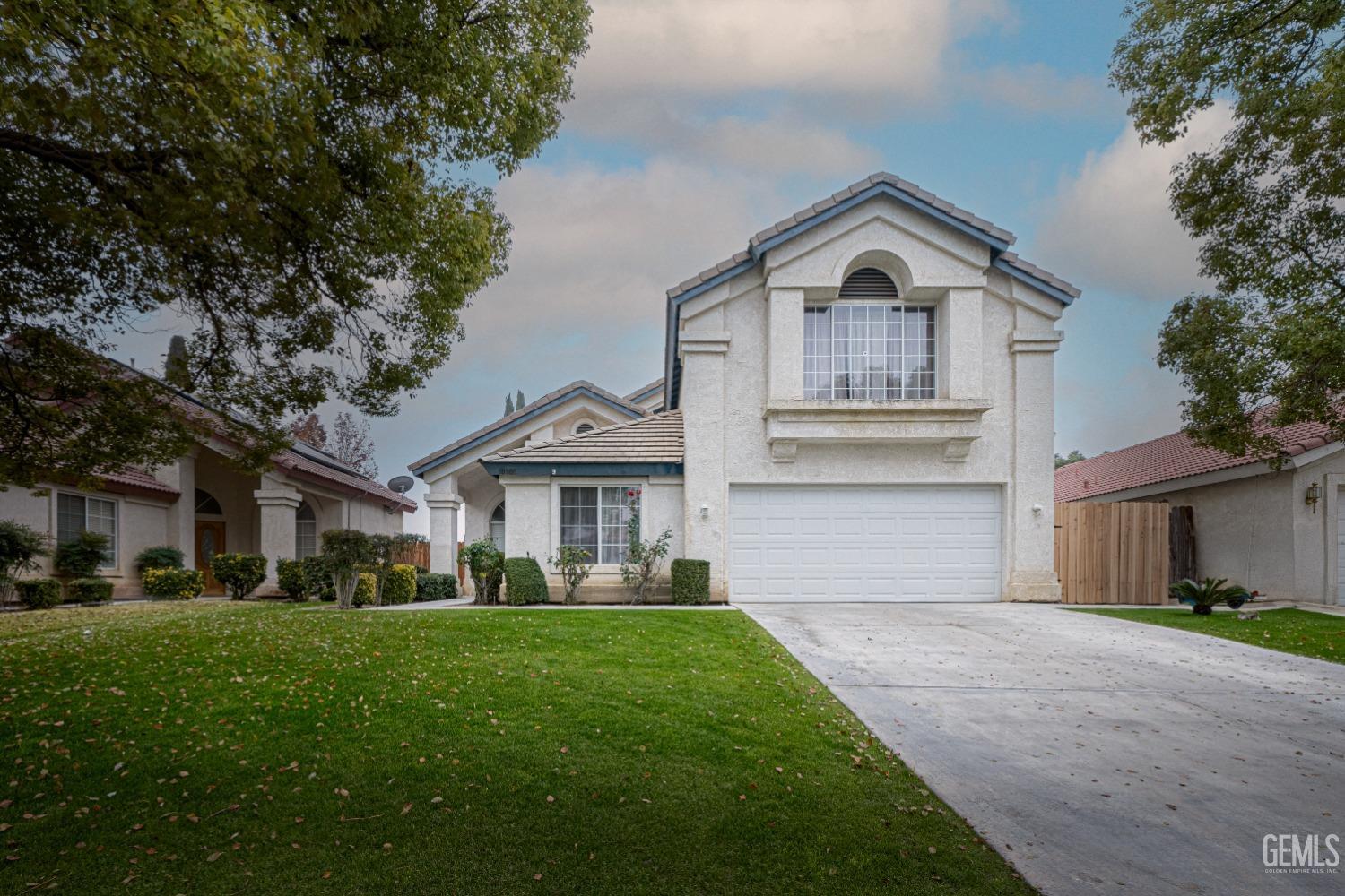Undisclosed Address Bakersfield, CA 93312 - Photo 2 of 29 a view of house with a big yard and large trees