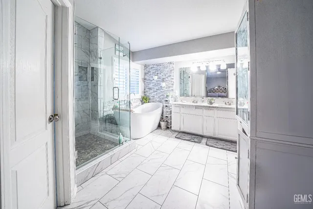 a bathroom with a tub shower and sink