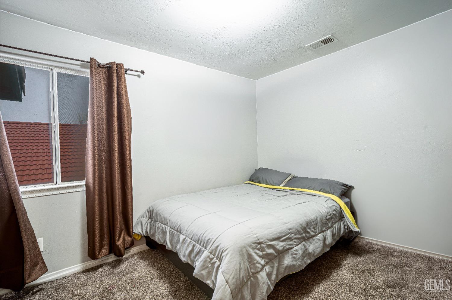 Undisclosed Address Bakersfield, CA 93312 - Photo 25 of 29 a bedroom with a bed and a window