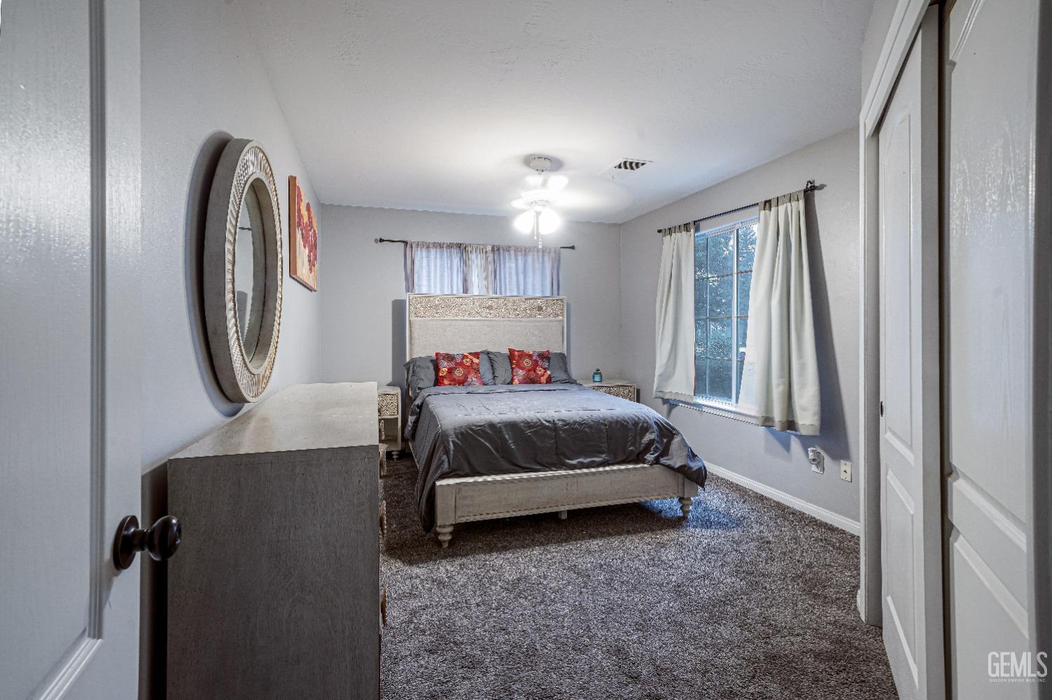 Undisclosed Address Bakersfield, CA 93312 - Photo 28 of 29 a bedroom with a bed and a mirror