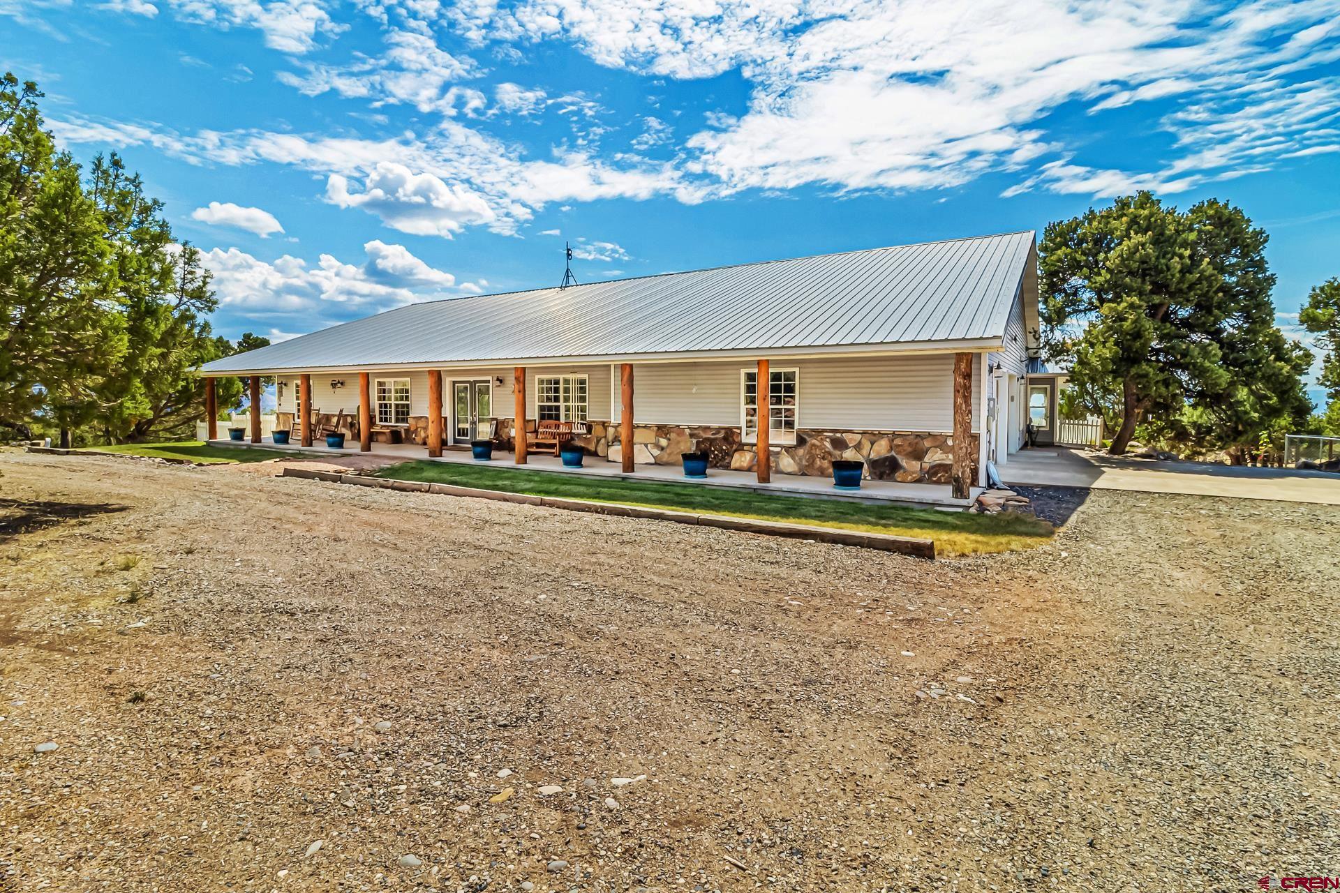 a view of house with outdoor space and swimming pool