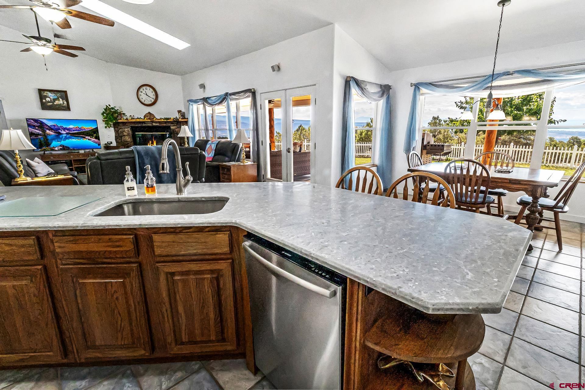 17656 2550th Road Cedaredge, CO 81413 - Photo 12 of 45 a kitchen with a table chairs and wooden floor