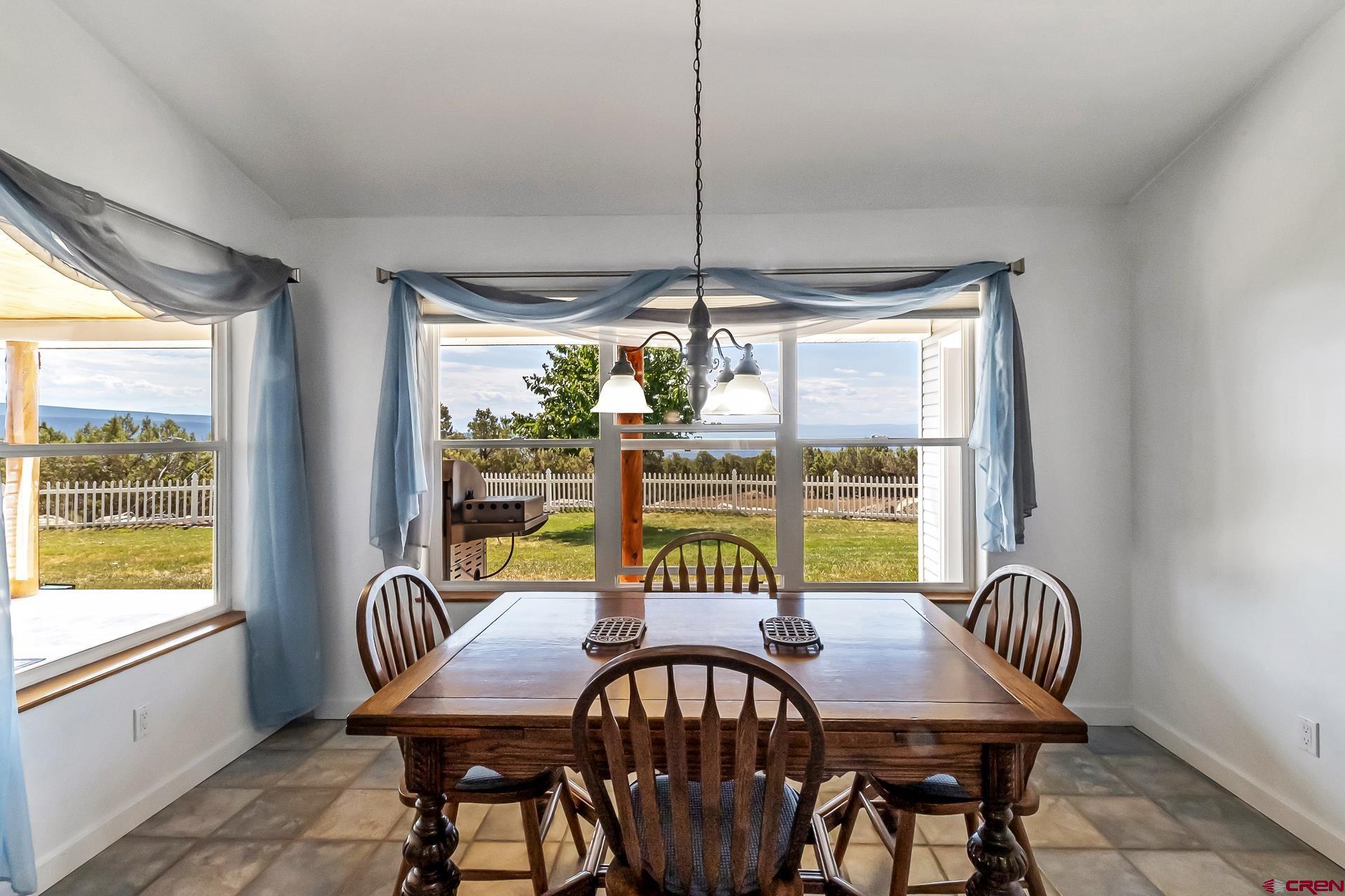 17656 2550th Road Cedaredge, CO 81413 - Photo 14 of 45 a view of a dining room with furniture window and outside view
