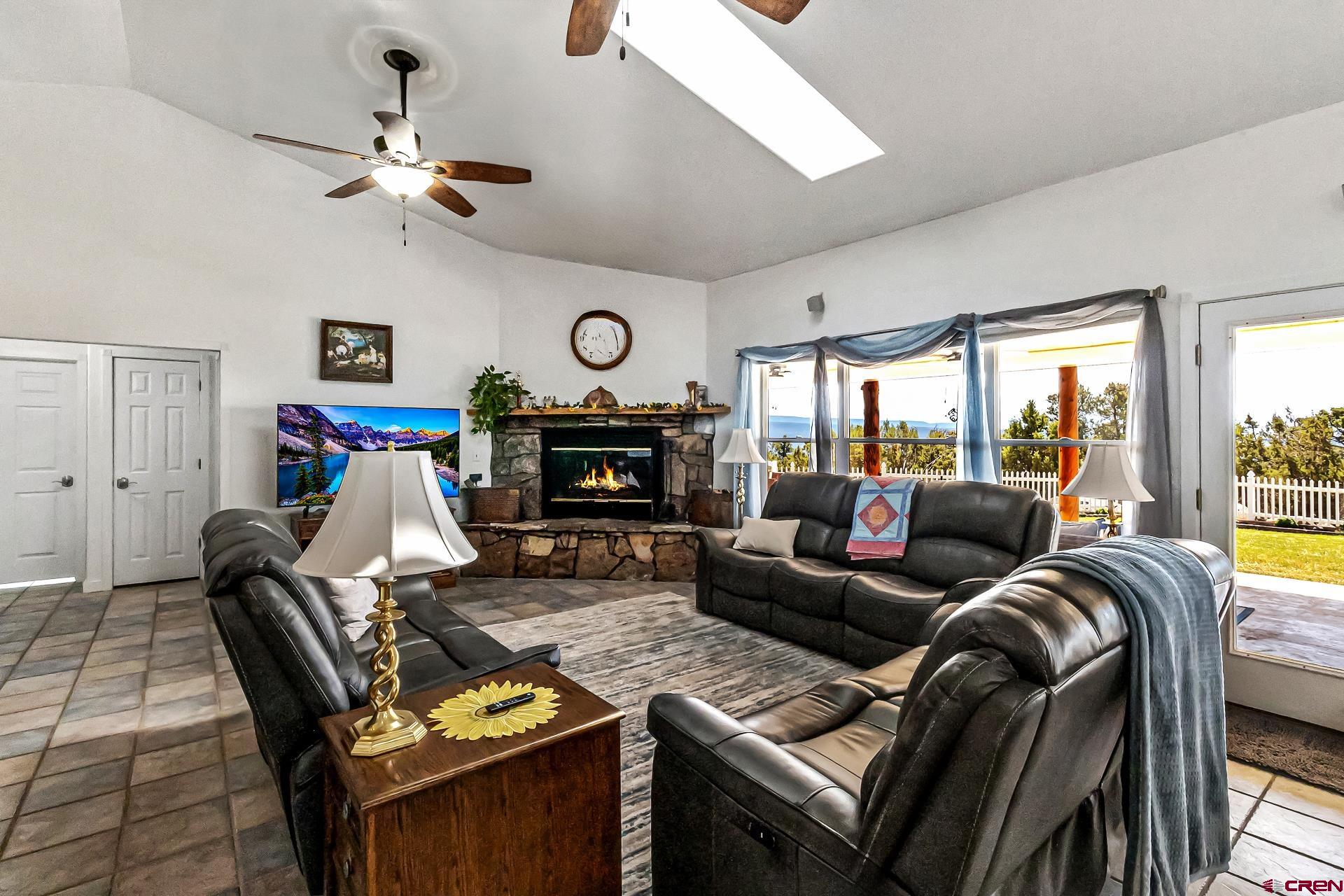17656 2550th Road Cedaredge, CO 81413 - Photo 16 of 45 a living room with furniture fireplace and flat screen tv
