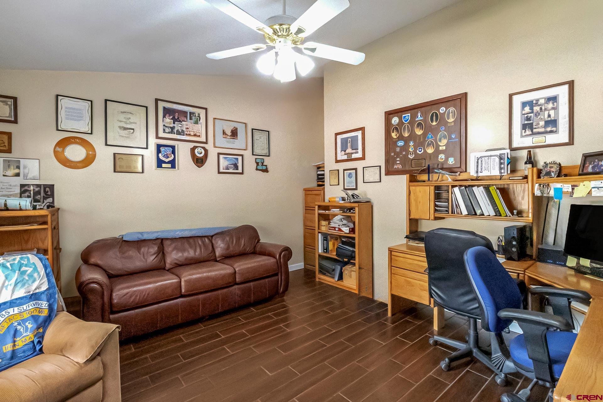 17656 2550th Road Cedaredge, CO 81413 - Photo 20 of 45 a living room with furniture and a bookshelf