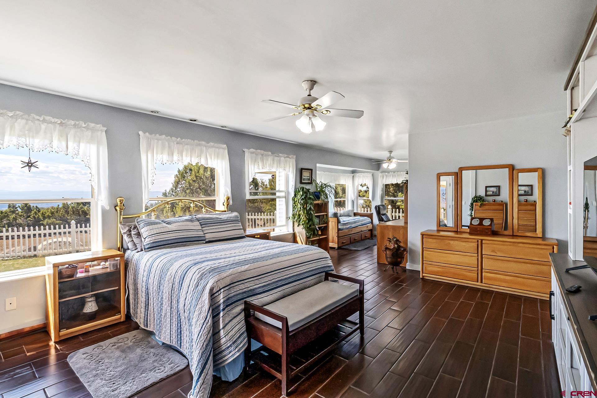 17656 2550th Road Cedaredge, CO 81413 - Photo 25 of 45 a bedroom with a bed and wooden floor