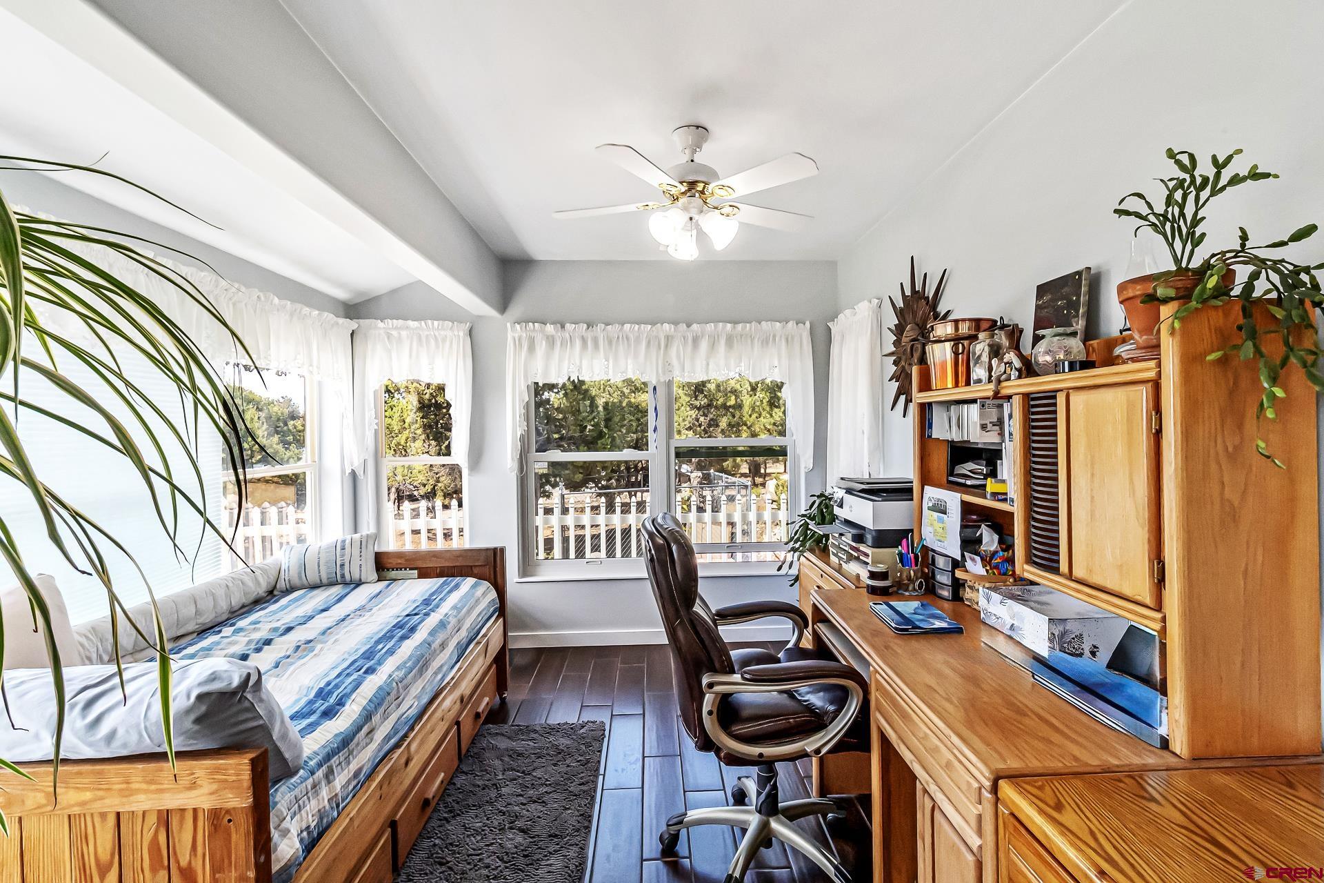 17656 2550th Road Cedaredge, CO 81413 - Photo 26 of 45 a bedroom with furniture and a window