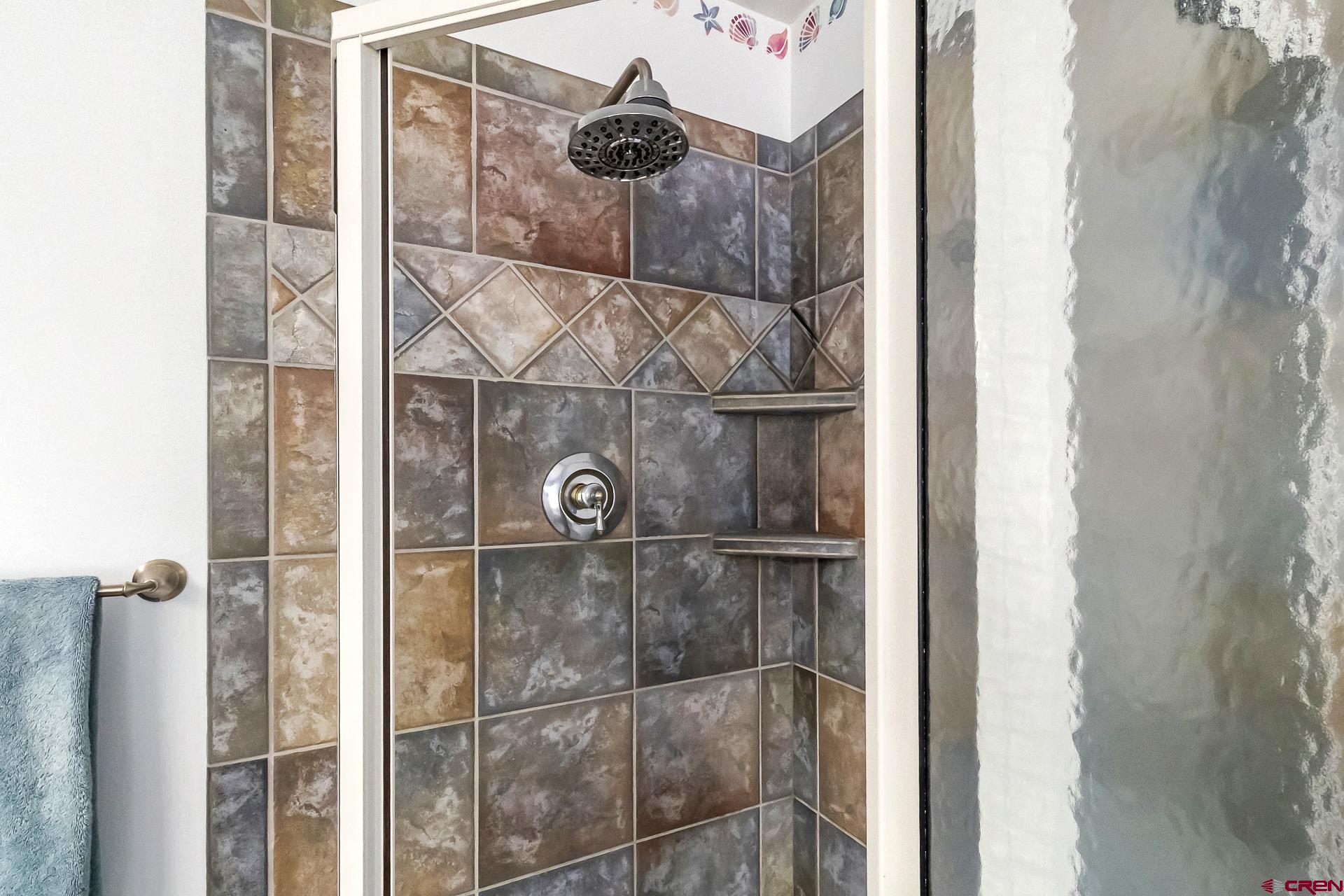 17656 2550th Road Cedaredge, CO 81413 - Photo 27 of 45 a bathroom with a glass shower door