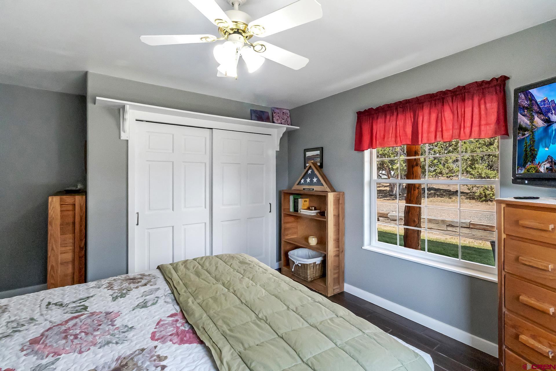 17656 2550th Road Cedaredge, CO 81413 - Photo 30 of 45 a bedroom with a bed and a large window