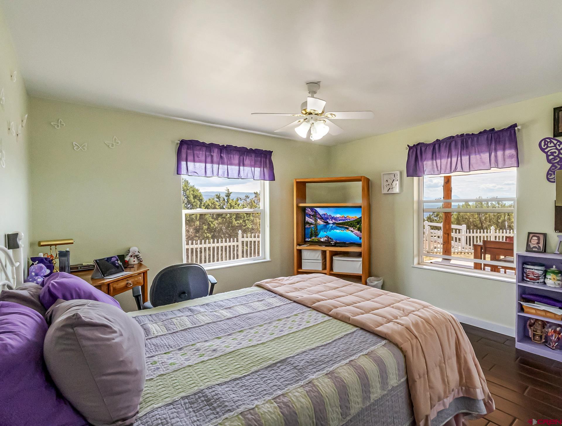 17656 2550th Road Cedaredge, CO 81413 - Photo 32 of 45 a bedroom with a bed dresser and a window