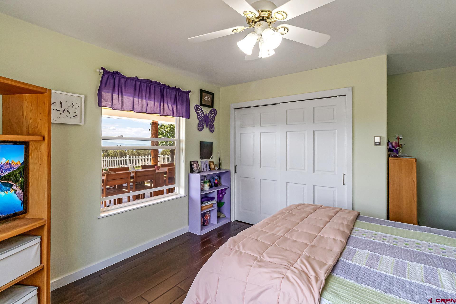 17656 2550th Road Cedaredge, CO 81413 - Photo 33 of 45 a bedroom with a bed and a chandelier