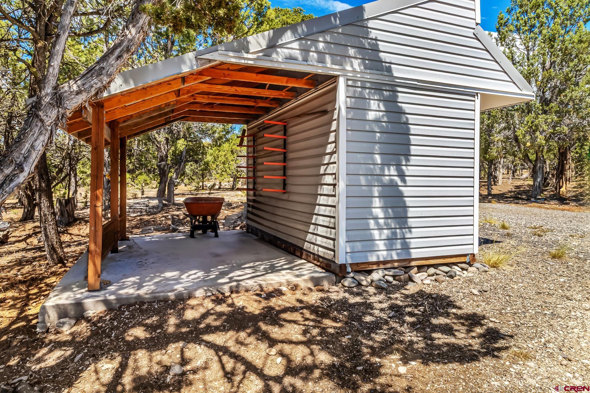 17656 2550th Road Cedaredge, CO 81413 - Photo 42 of 45 a backyard of a house with barbeque oven table and chairs