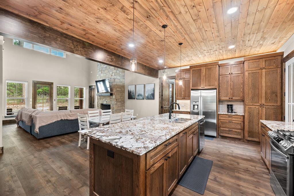 483 Spout Springs Road Pottsboro, TX 75076 - Photo 14 of 35 a living room with stainless steel appliances kitchen island granite countertop furniture and a kitchen view