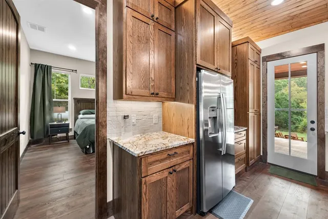 a kitchen that has a lot of cabinets and stainless steel appliances