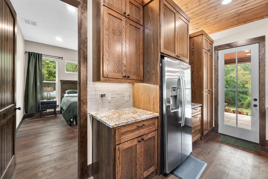 483 Spout Springs Road Pottsboro, TX 75076 - Photo 19 of 35 a kitchen that has a lot of cabinets and stainless steel appliances