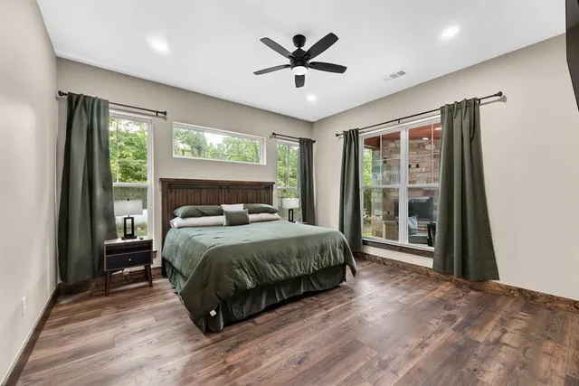 a spacious bedroom with a bed and a large window