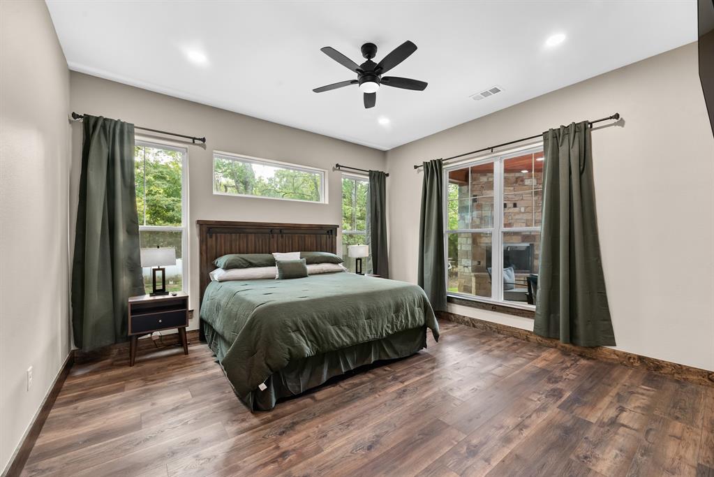 483 Spout Springs Road Pottsboro, TX 75076 - Photo 20 of 35 a spacious bedroom with a bed and a large window