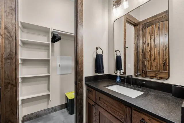 a bathroom with a granite countertop sink and a mirror