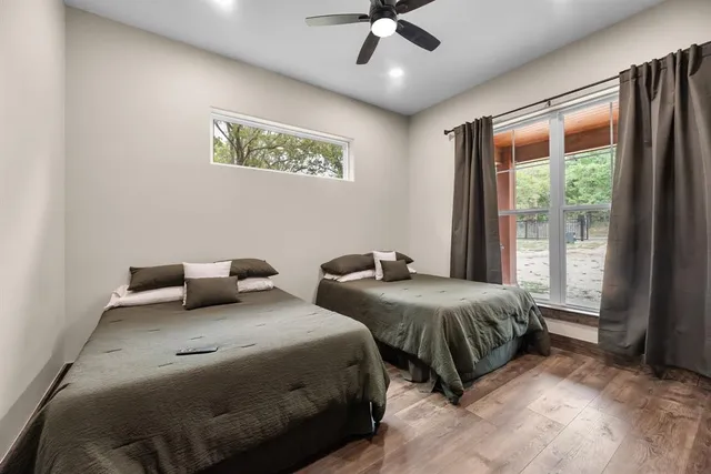 a bedroom with two beds and a large window