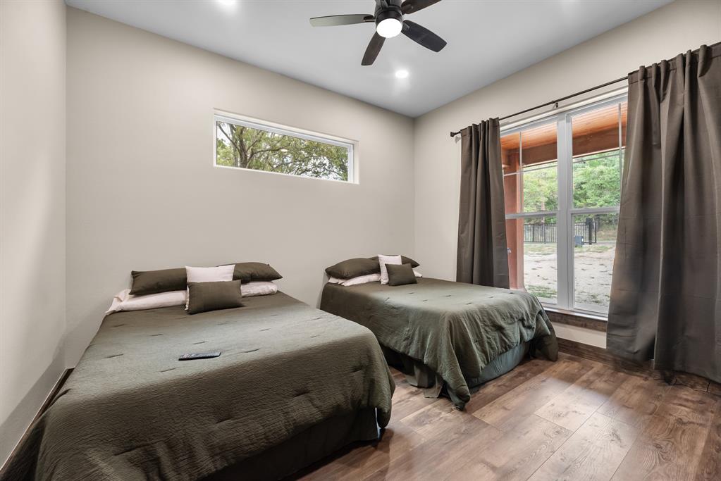 483 Spout Springs Road Pottsboro, TX 75076 - Photo 23 of 35 a bedroom with two beds and a large window