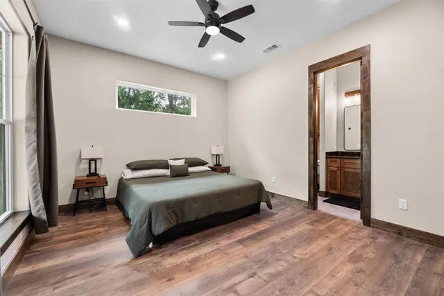a bedroom with a bed and a ceiling fan
