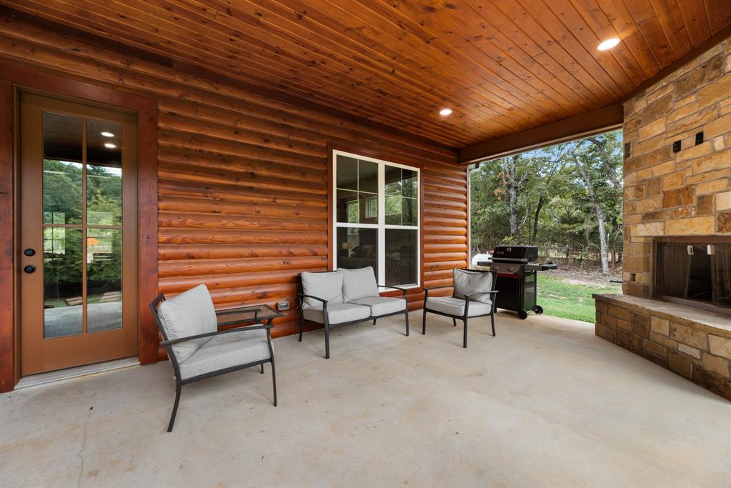 483 Spout Springs Road Pottsboro, TX 75076 - Photo 30 of 35 a view of a livingroom with furniture and a fireplace