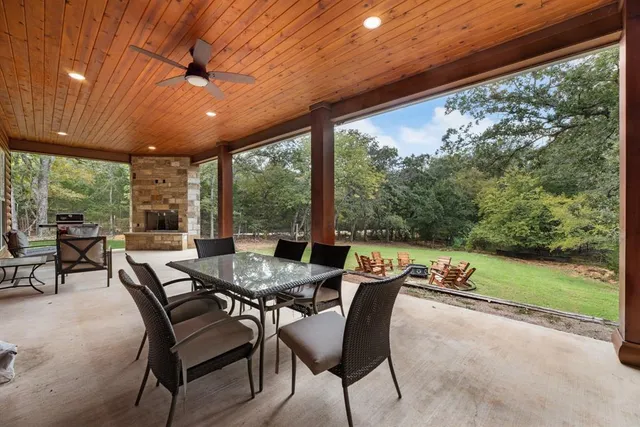 a dining room with furniture and garden view