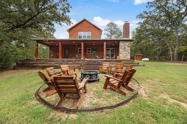 a backyard of a house with table and chairs