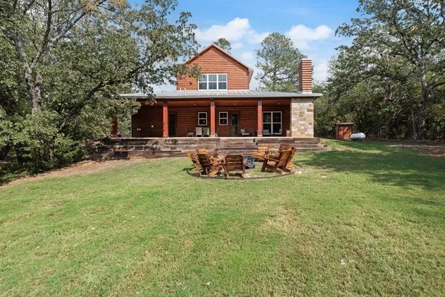 a front view of house with outdoor seating yard and green space