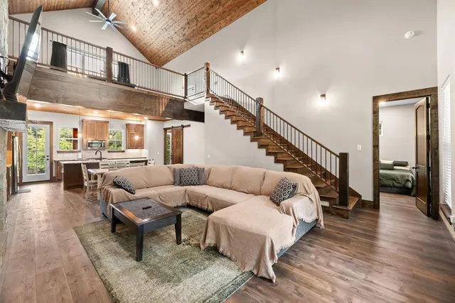 a living room with furniture and wooden floor