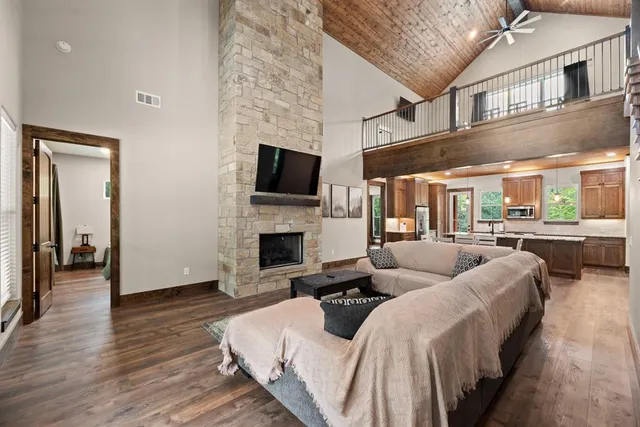 a large bedroom with bed and a fireplace