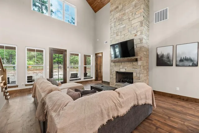a living room with furniture a flat screen tv and a fireplace