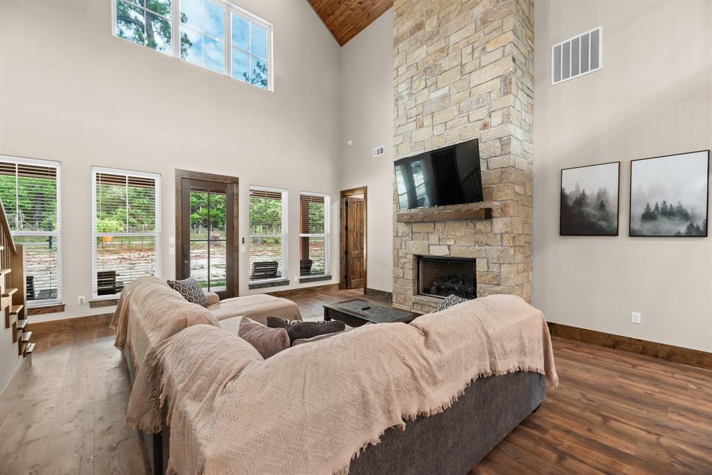 483 Spout Springs Road Pottsboro, TX 75076 - Photo 8 of 35 a living room with furniture a flat screen tv and a fireplace