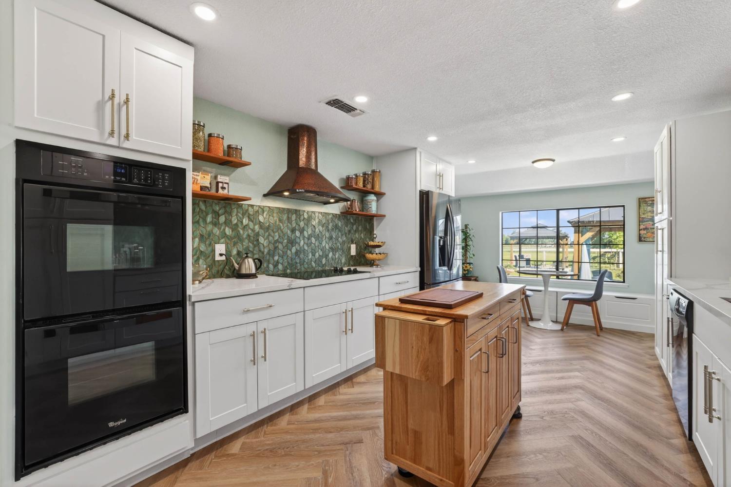 11875 Arno Road Wilton, CA 95693 - Photo 13 of 65 a kitchen with stainless steel appliances granite countertop a stove and a sink