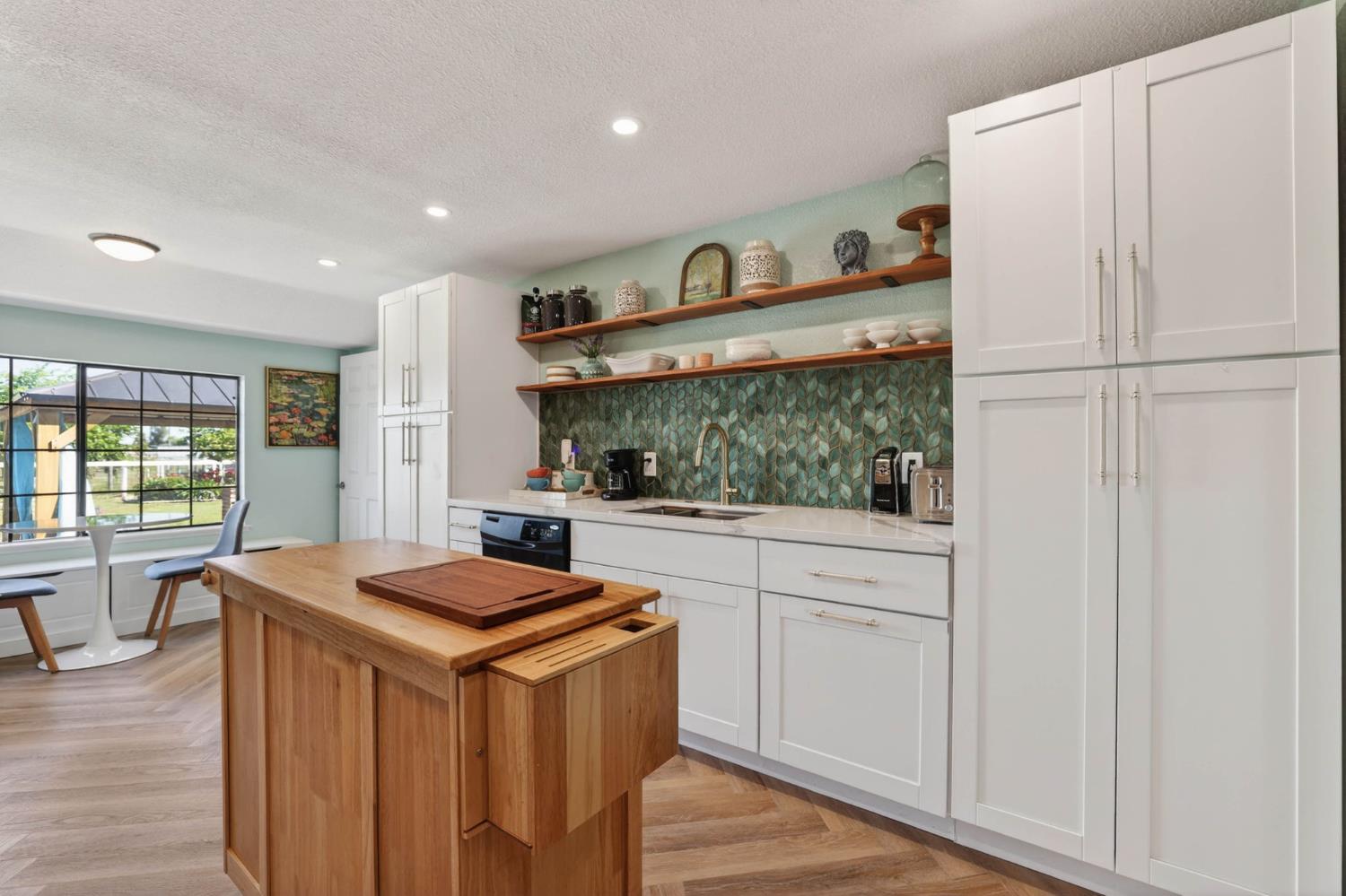 11875 Arno Road Wilton, CA 95693 - Photo 16 of 65 a kitchen with stainless steel appliances granite countertop a refrigerator a sink a stove and white cabinets with wooden floor