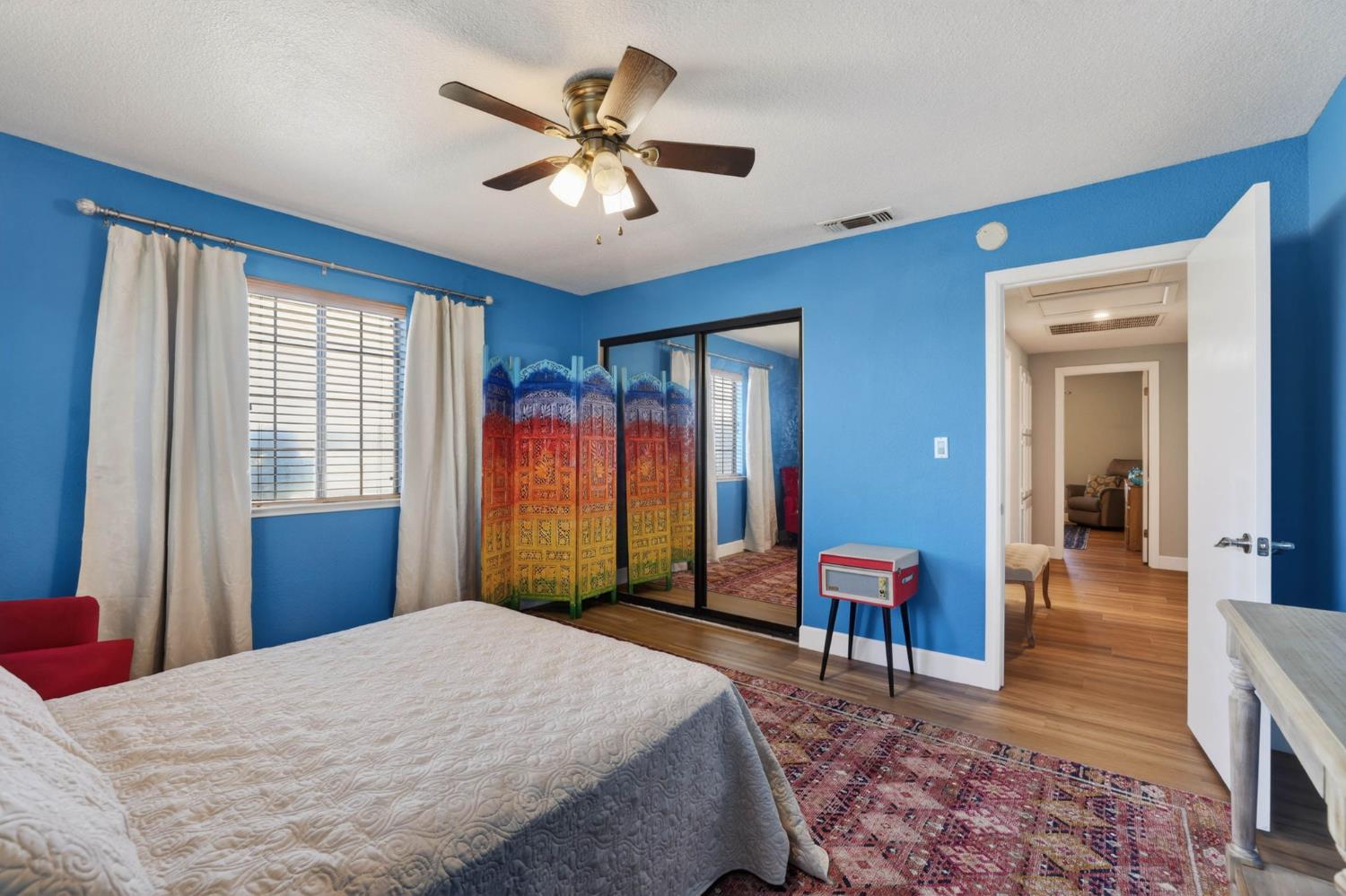 11875 Arno Road Wilton, CA 95693 - Photo 19 of 65 a bedroom with a bed and a chandelier
