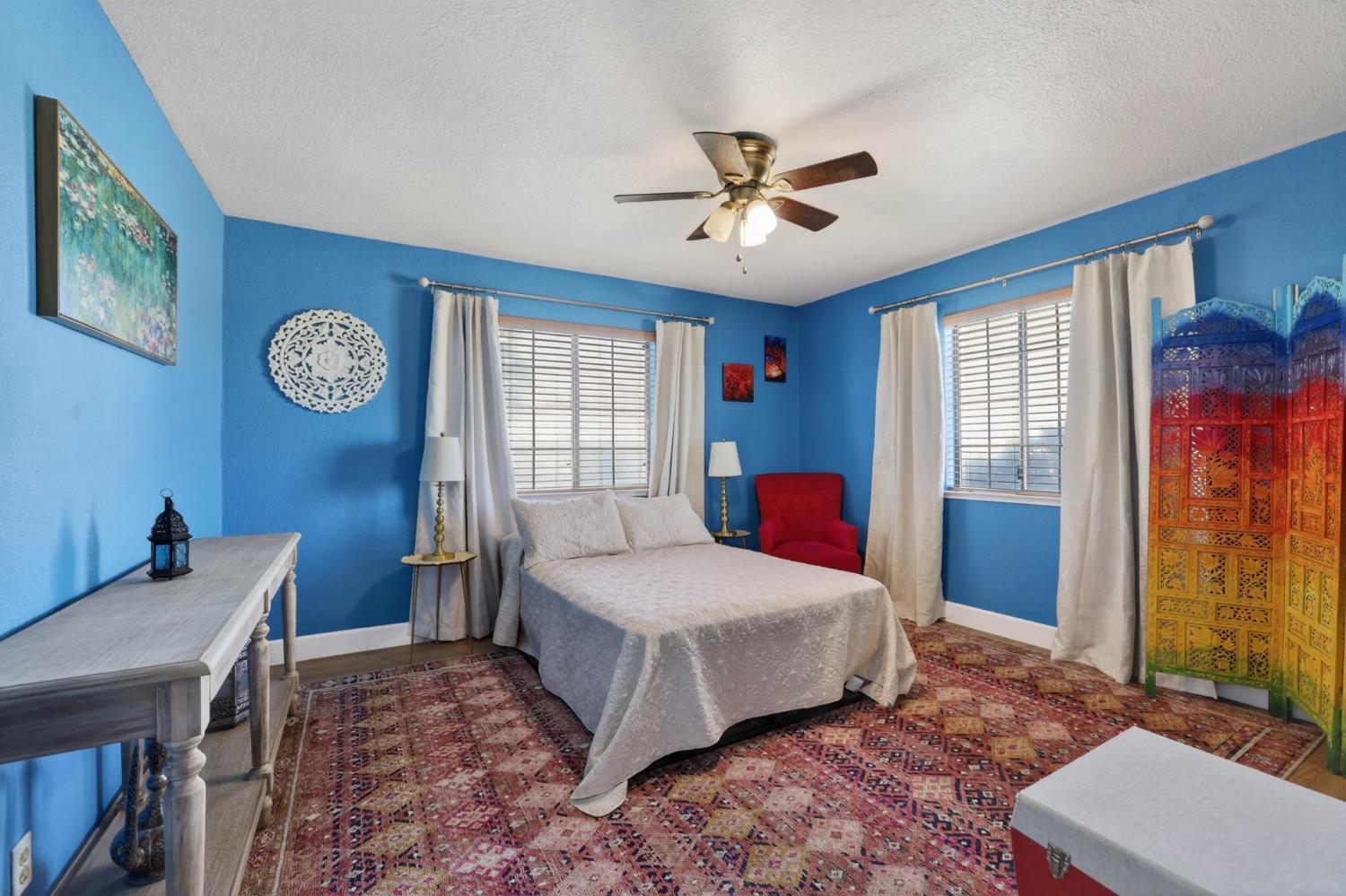 11875 Arno Road Wilton, CA 95693 - Photo 20 of 65 a bedroom with a bed and a chandelier