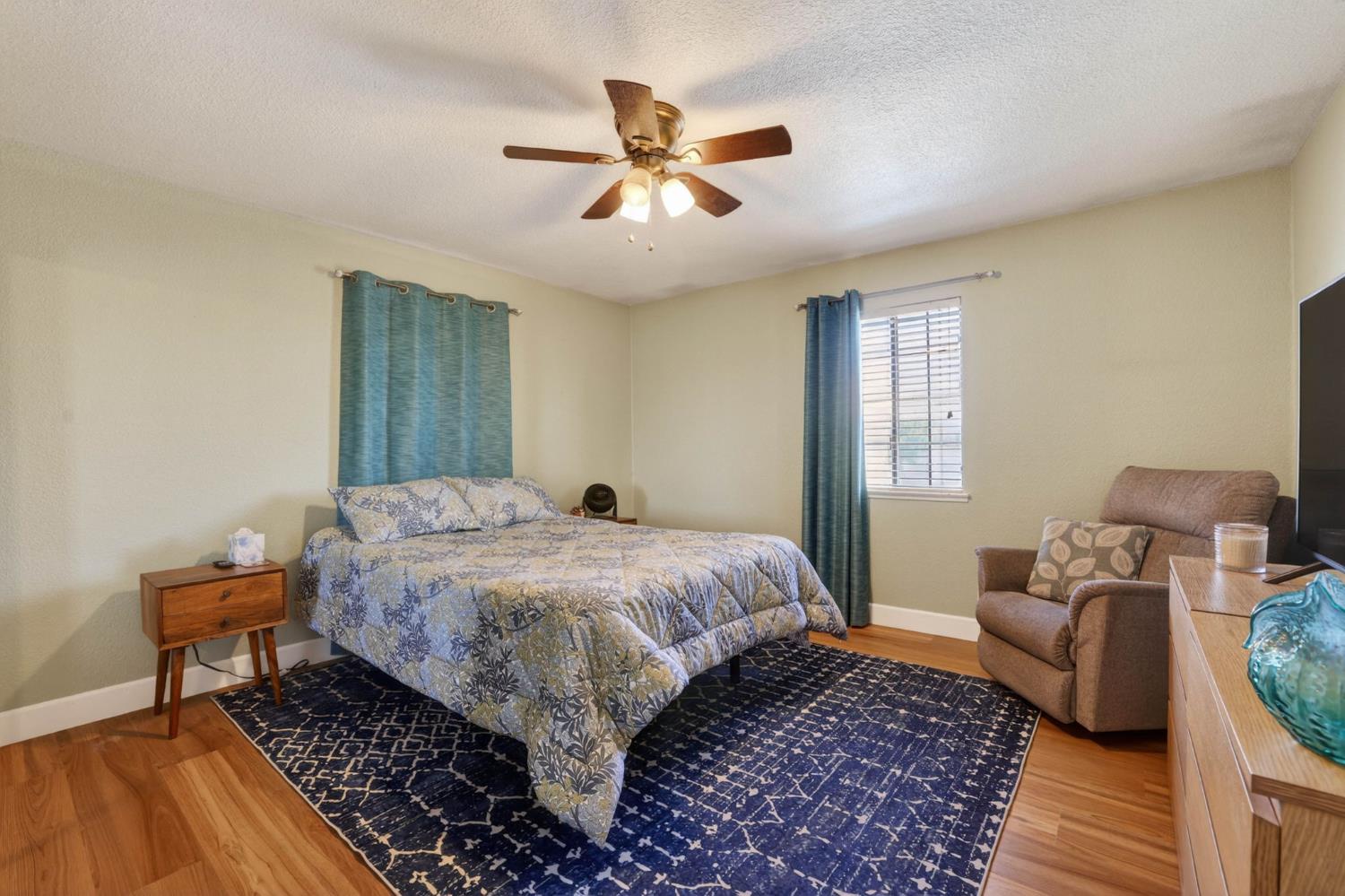 11875 Arno Road Wilton, CA 95693 - Photo 26 of 65 a bedroom with a bed and wooden floor