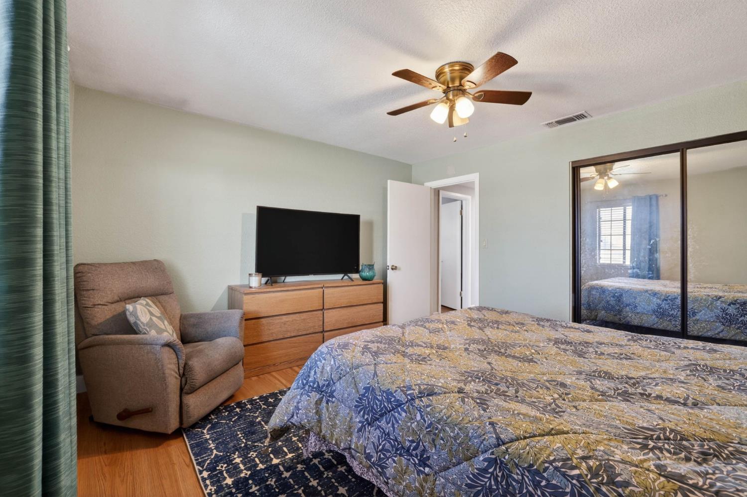 11875 Arno Road Wilton, CA 95693 - Photo 27 of 65 a bedroom with a bed a couch and a flat screen tv