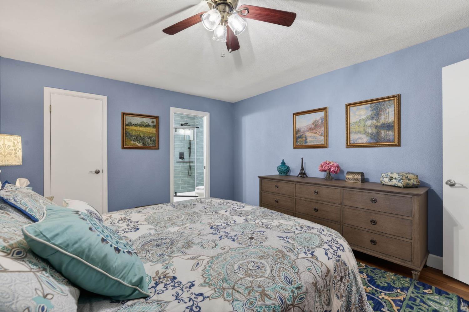 11875 Arno Road Wilton, CA 95693 - Photo 29 of 65 a bedroom with a bed and a chandelier