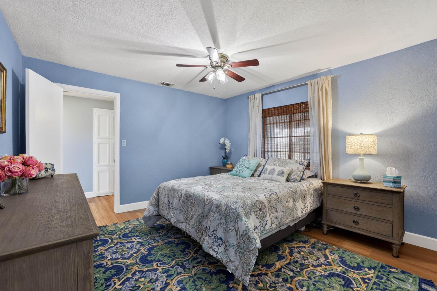 11875 Arno Road Wilton, CA 95693 - Photo 30 of 65 a bedroom with a bed and a chandelier