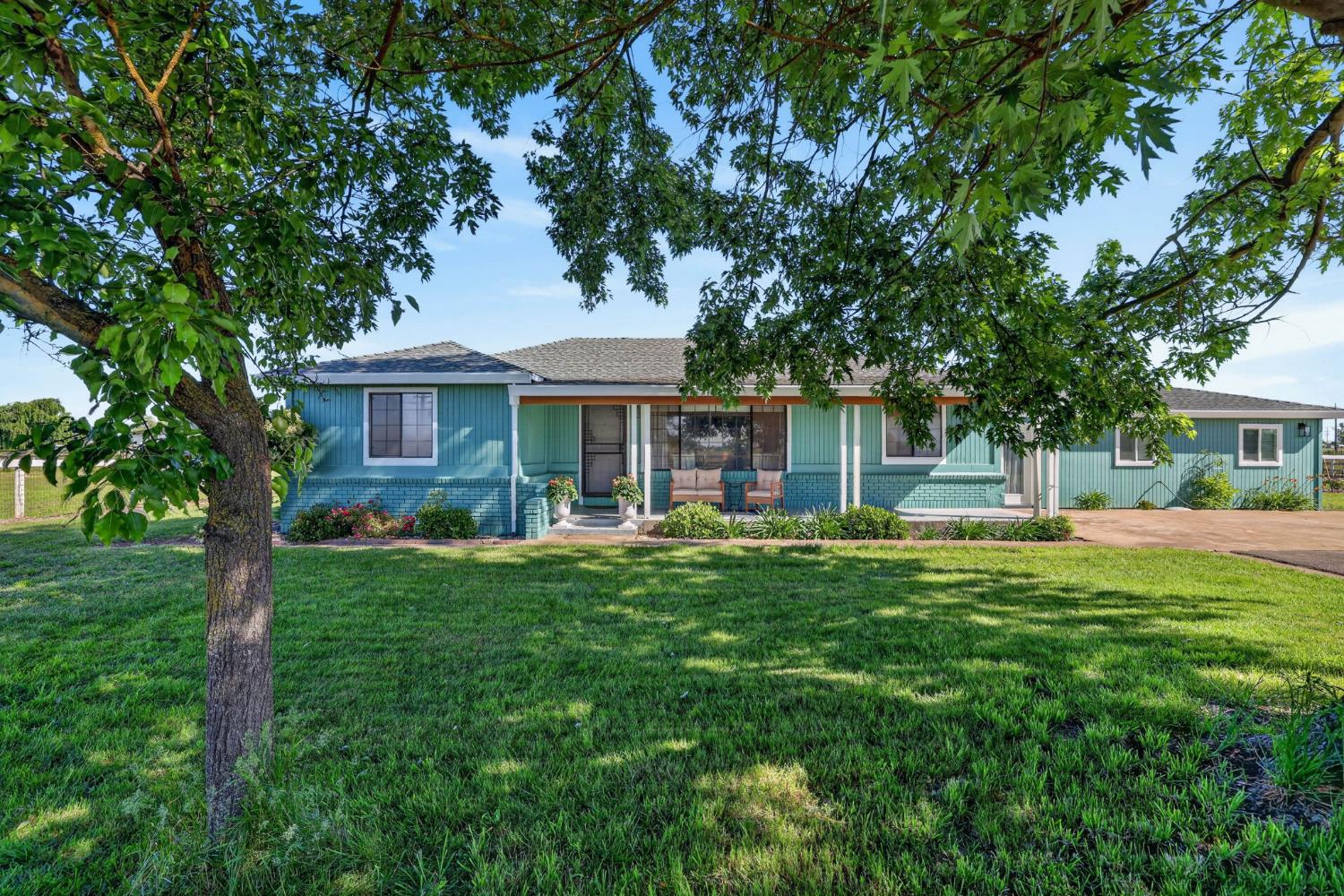 11875 Arno Road Wilton, CA 95693 - Photo 3 of 65 a front view of a house with a garden