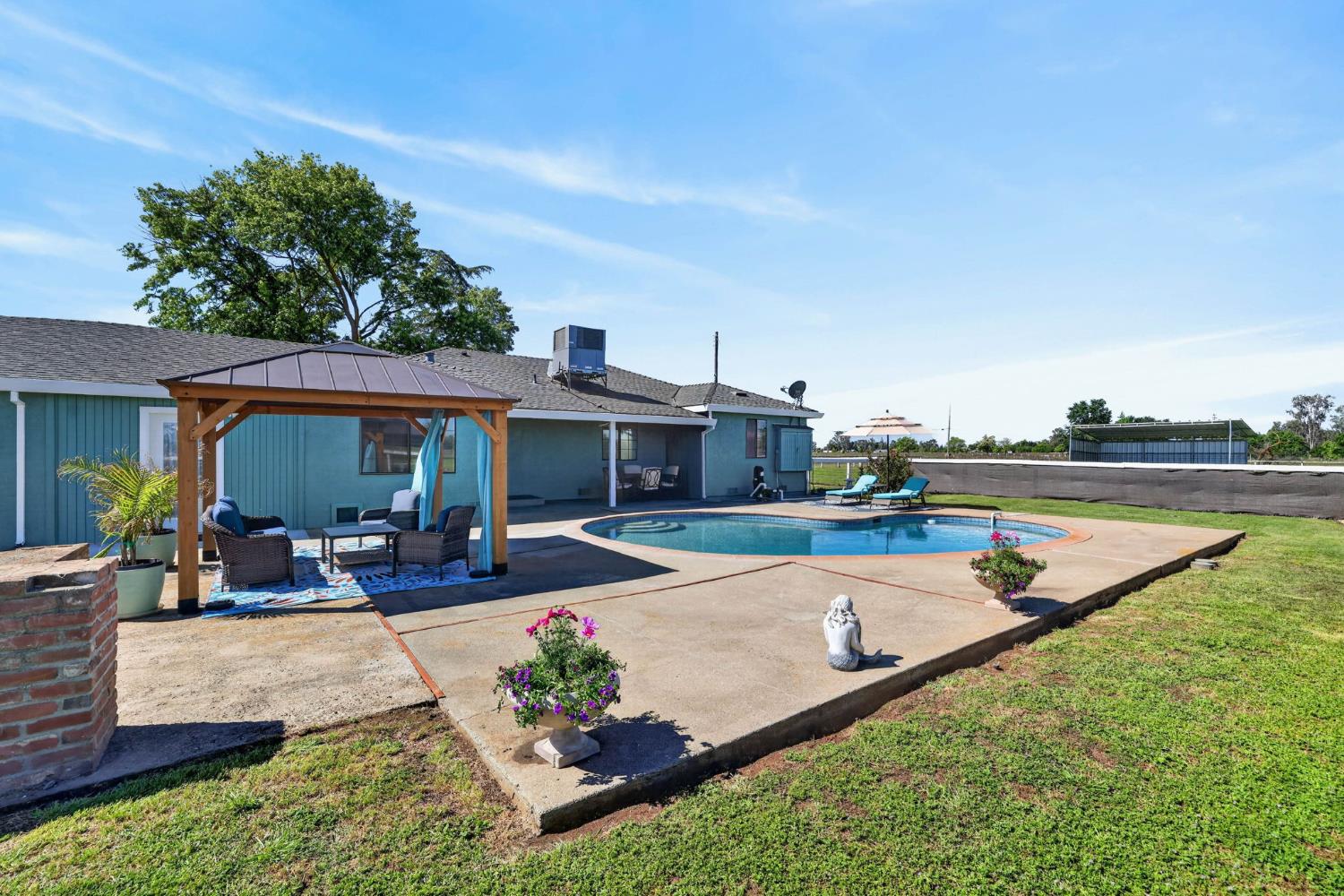 11875 Arno Road Wilton, CA 95693 - Photo 46 of 65 a view of a house with swimming pool and sitting area