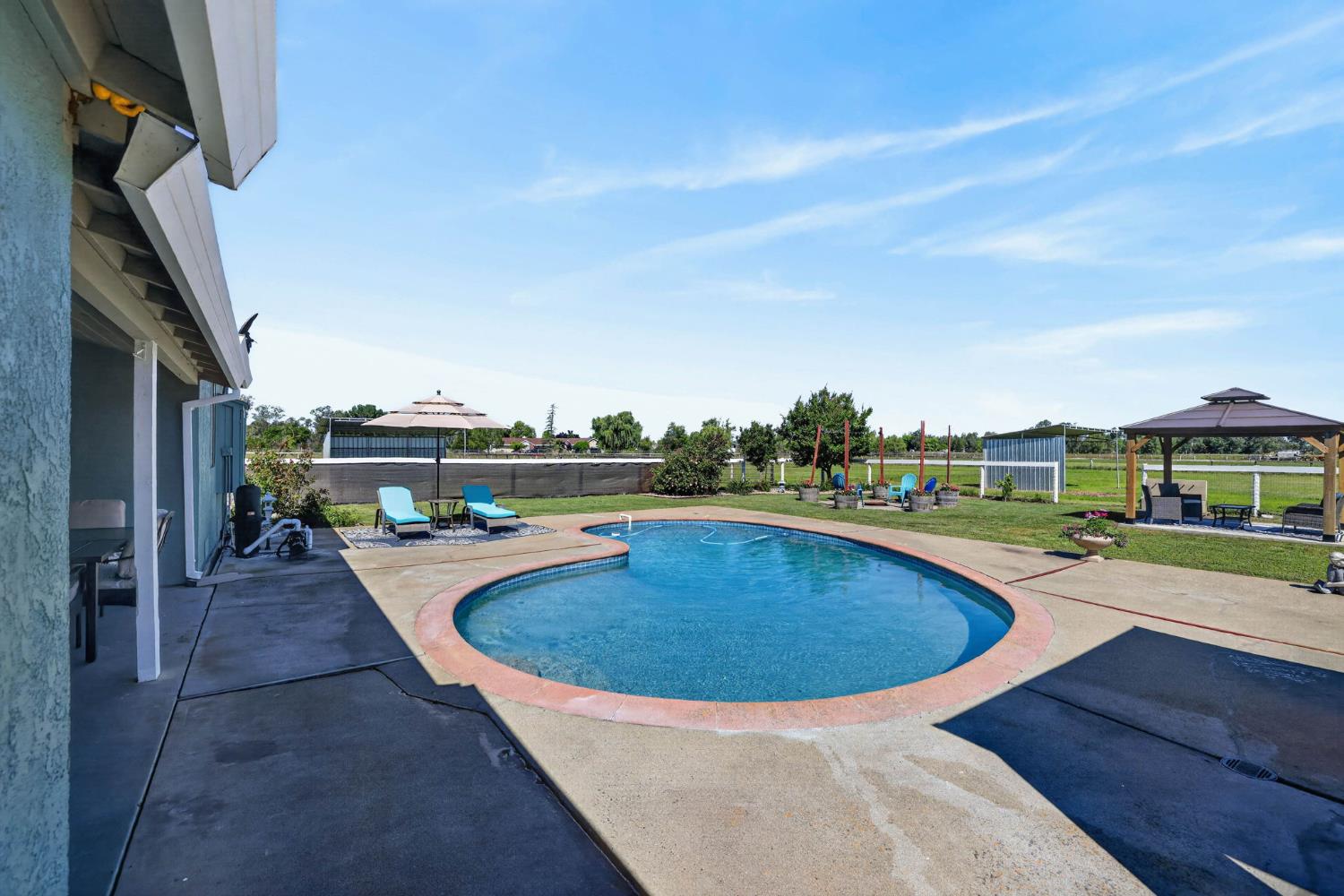 11875 Arno Road Wilton, CA 95693 - Photo 47 of 65 a view of a swimming pool with a lounge chair