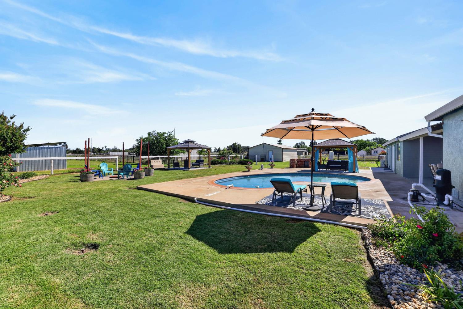 11875 Arno Road Wilton, CA 95693 - Photo 48 of 65 a view of a house with swimming pool and yard