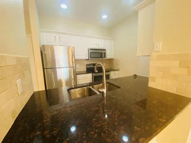 a view of a kitchen with a sink