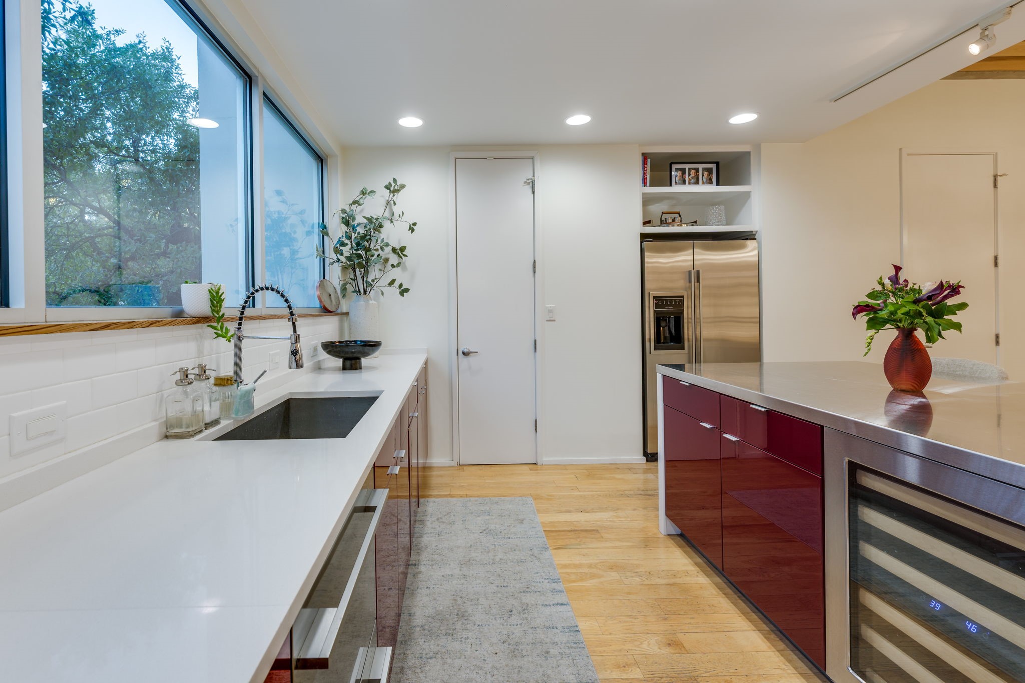 2301 South 5th Street, Unit 5 Austin, TX 78704 - Photo 18 of 39 Kitchen featuring dishwasher, sink, wine cooler, stainless steel fridge with ice dispenser, and light wood-type flooring