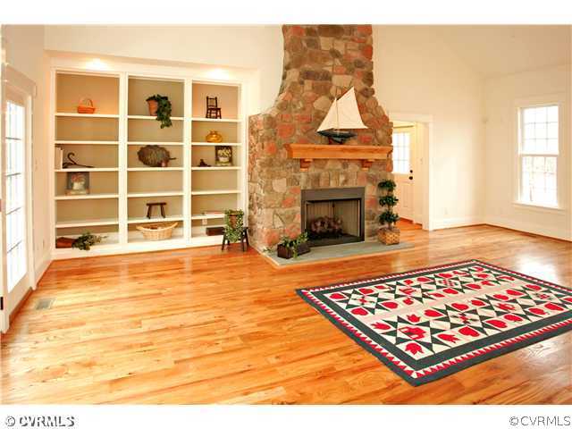 15931 Alsdell Road Midlothian, VA 23112 - Photo 3 of 12 a living room with a rug pool table and a fireplace